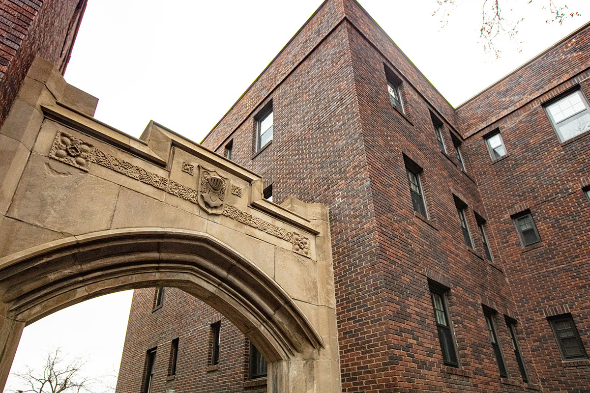A phot of the outside of the building detailing the beautiful stone arch work.